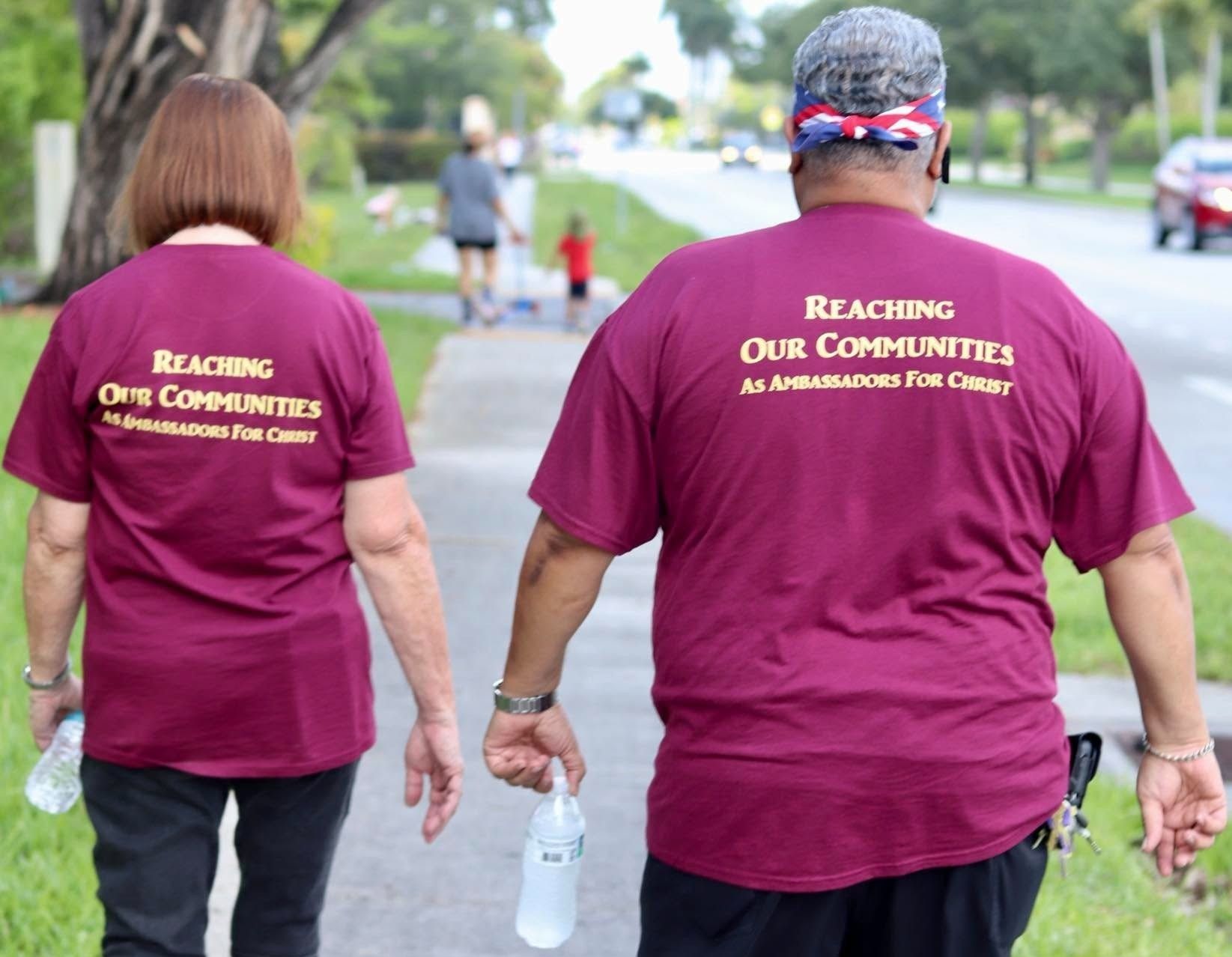 Two AFCO 5:20 outreach volunteers walking together through a Florida neighborhood.